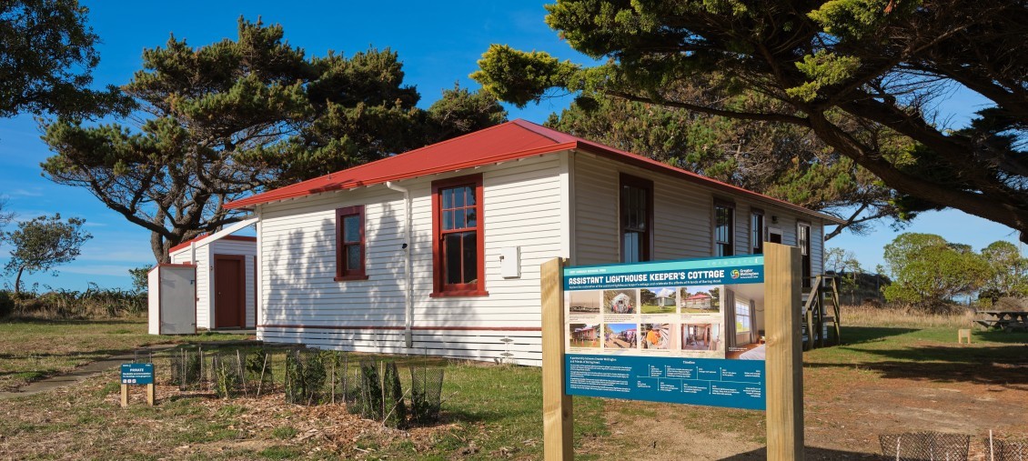 The lightkeepers cottage, a white building with red roof and trim