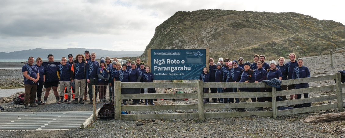 Rōpū Tiaki standing beside the entry sign to Ngā Roto o Parangarahu