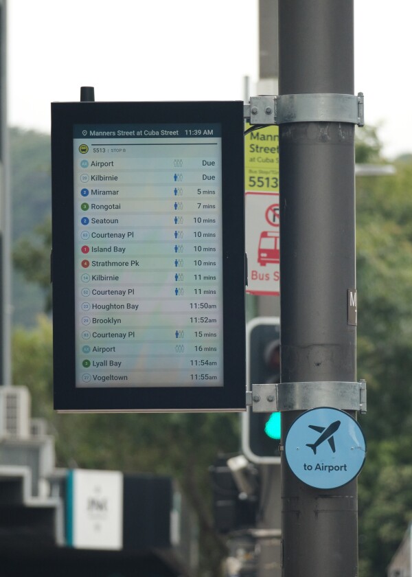 A digital timetable sign at a bus stop