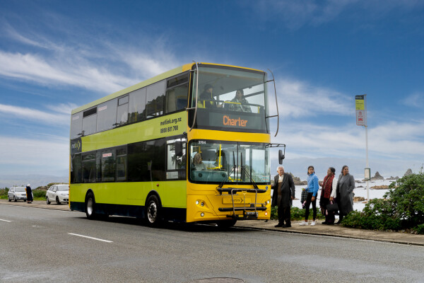People getting onto a double decker bus